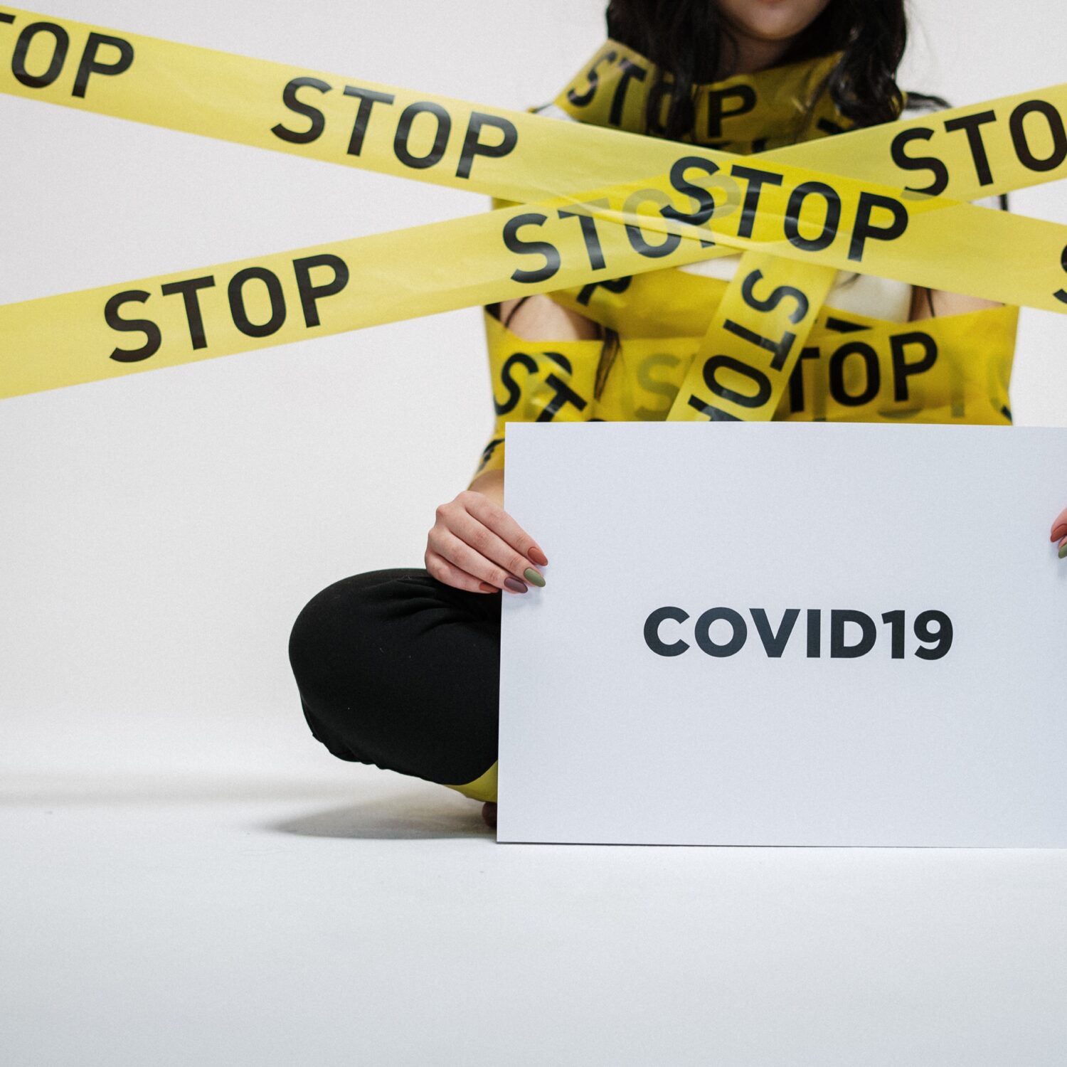 Woman holding Covid-19 sign
