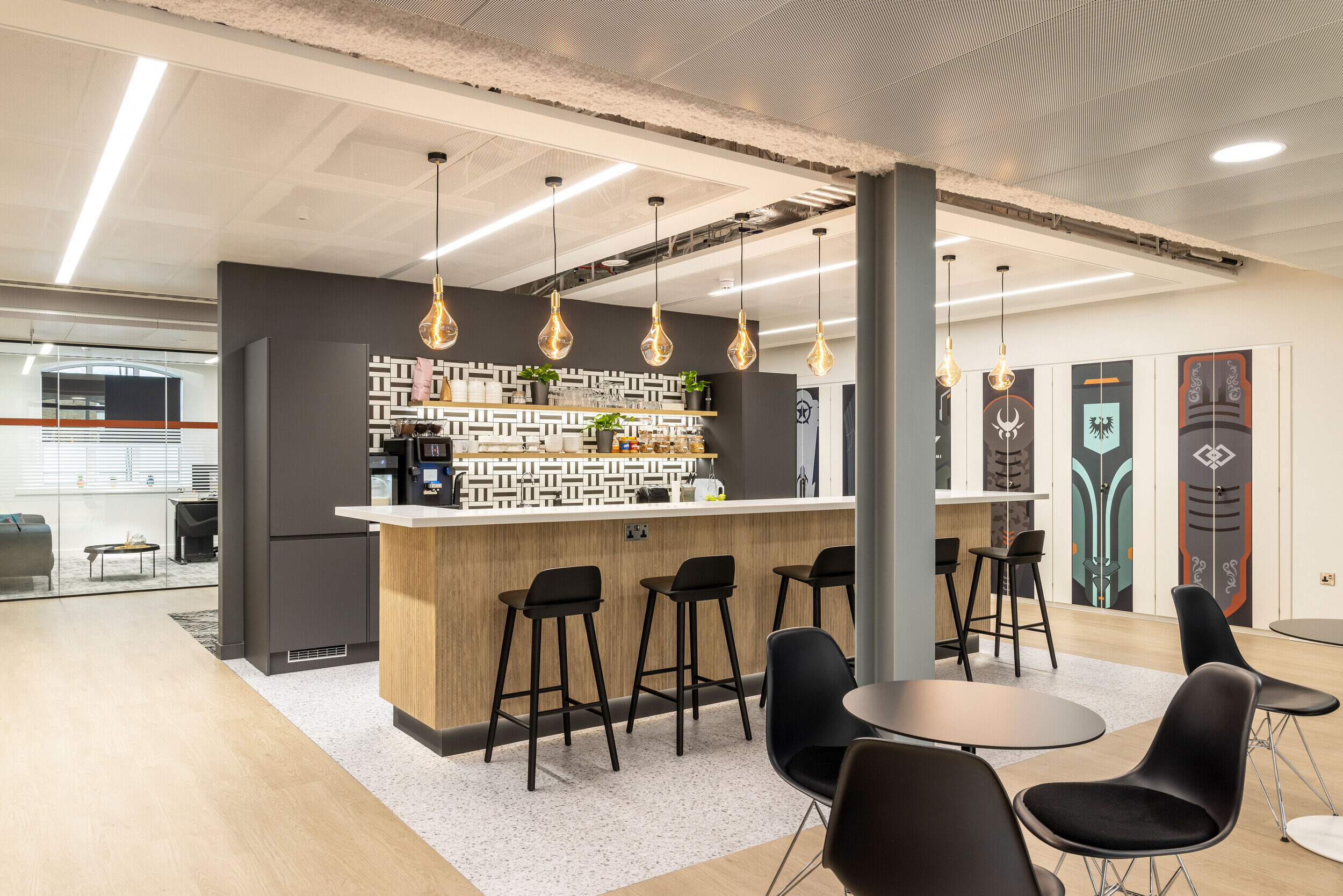 Spacious breakout area in CCP Games' office designed by Two, with a central teapoint, bar seating, and collaborative zones.