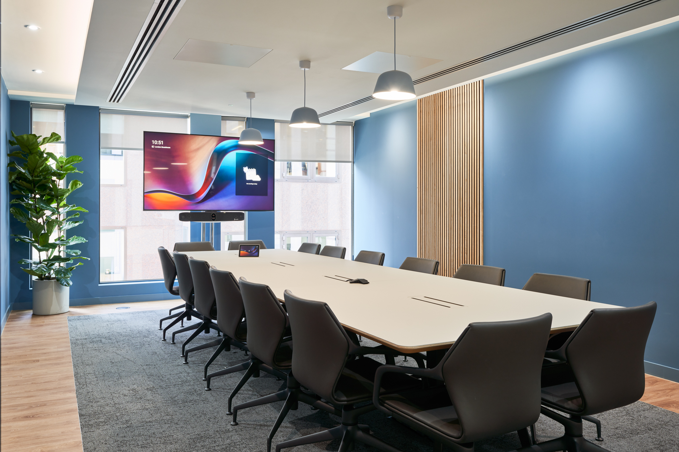 Large boardroom in the KPI Ocean Connect office, featuring a long table, modern chairs, and a vibrant blue feature wall.