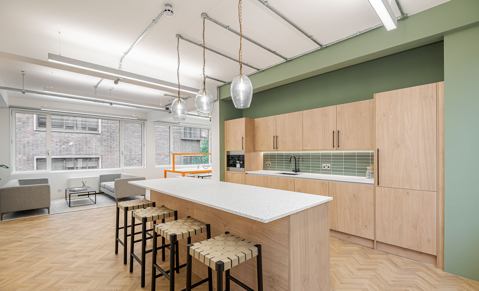 Chic office kitchen on Berry Street designed by Two, equipped with modern bar stools and a stylish wooden kitchenette.