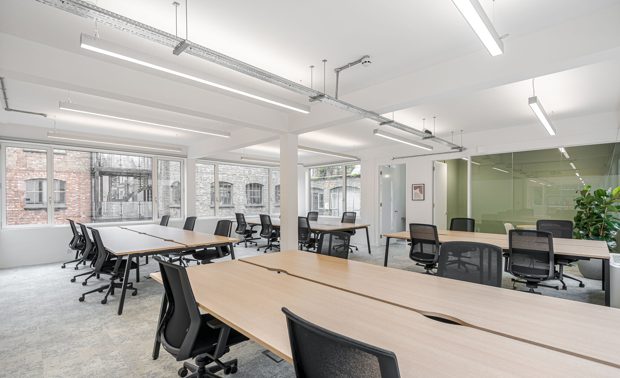 Open office space designed by Two on Berry Street featuring modern conference tables and natural light.