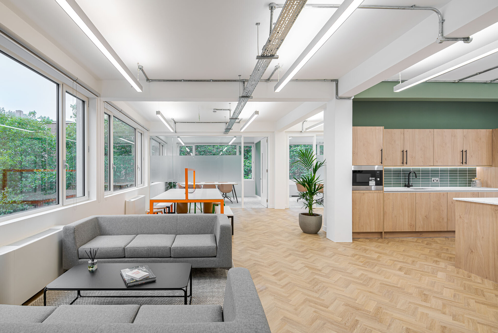 Spacious office lounge at Berry Street designed by Two, integrating relaxed seating areas with modern décor and ample lighting.