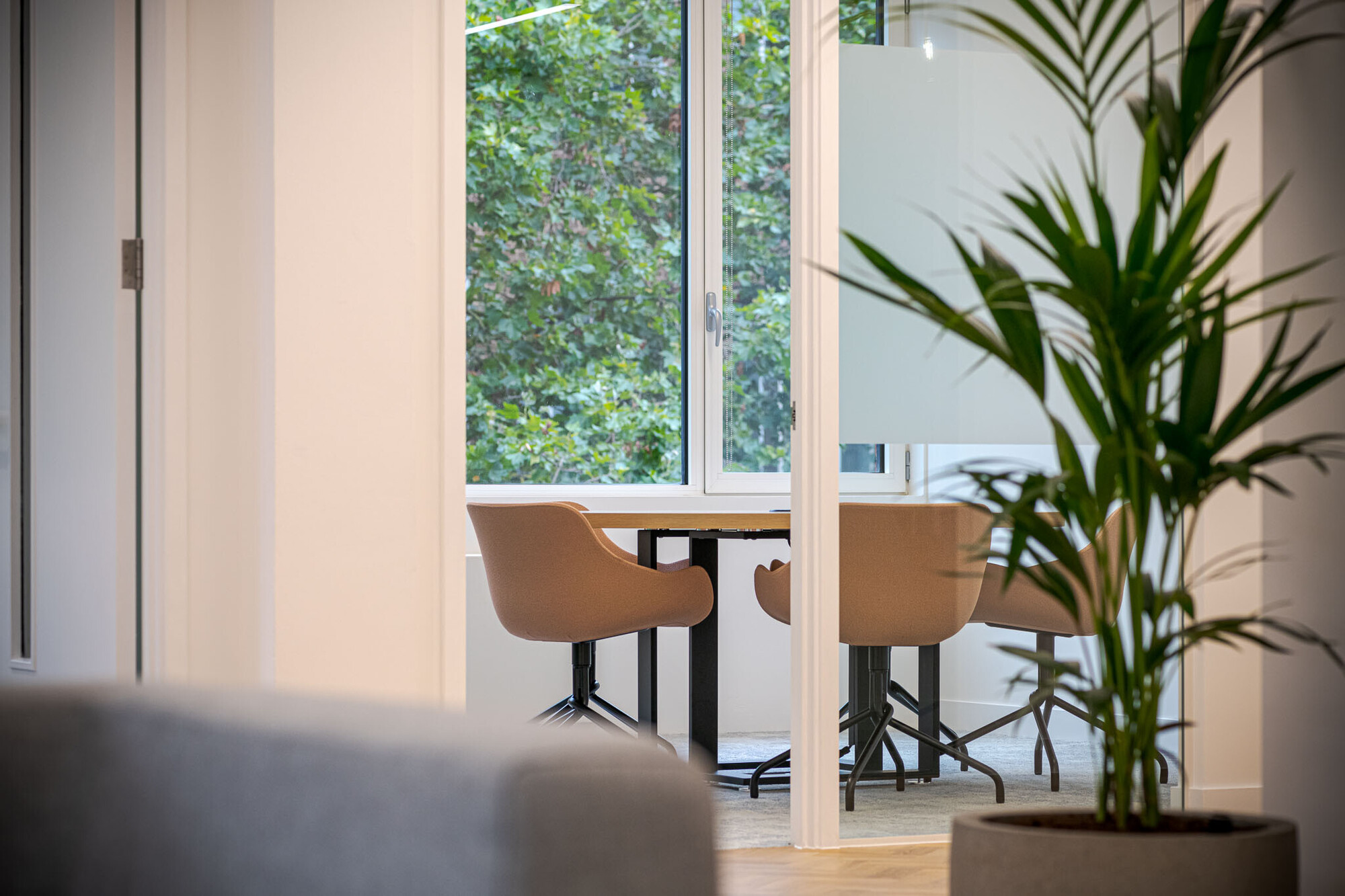 Casual office meeting area at Berry Street designed by Two, showcasing a creative space with unique pendant lighting and comfortable seating.