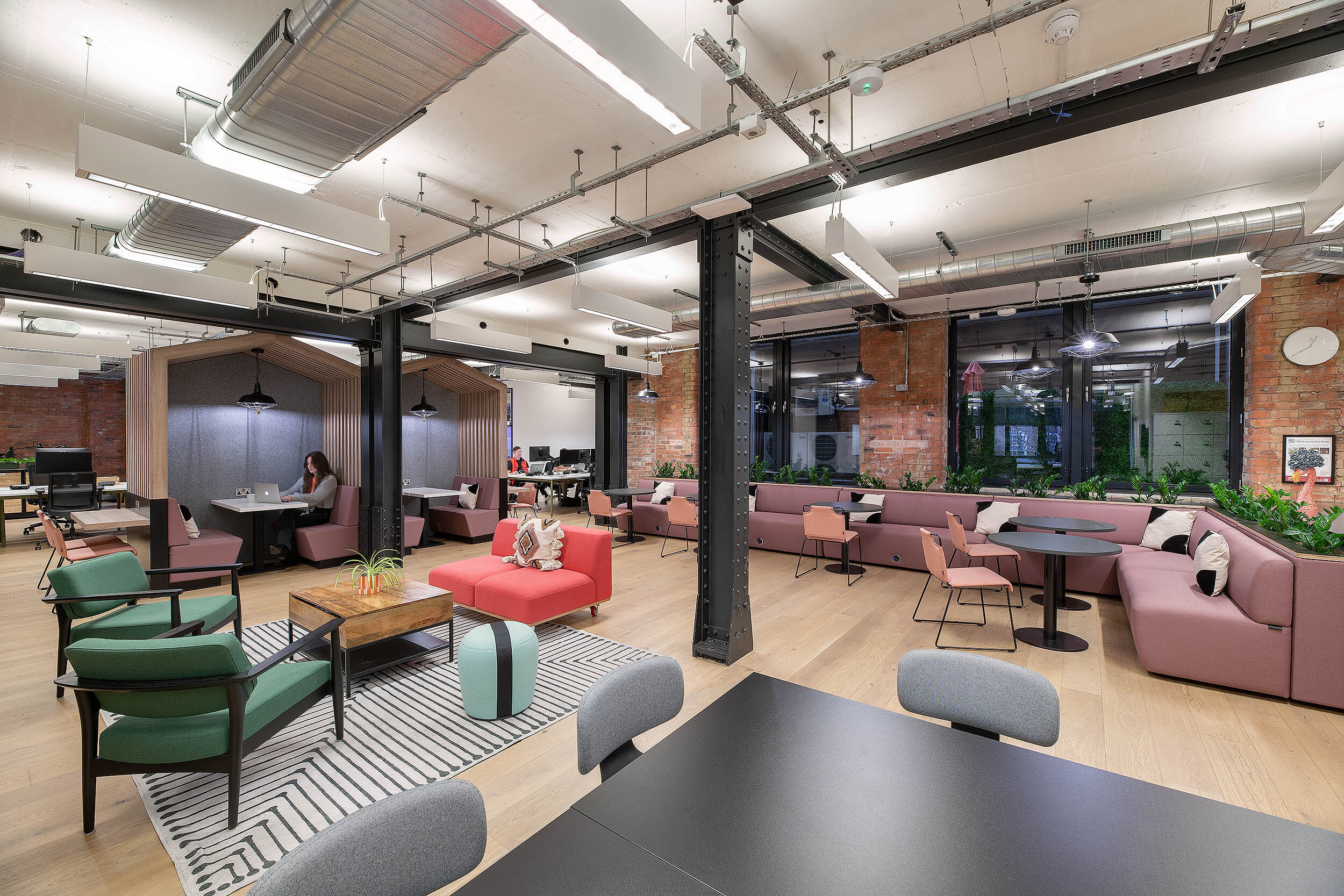 Open-plan office showcasing flexible seating areas, vibrant furniture, and collaborative workspaces.