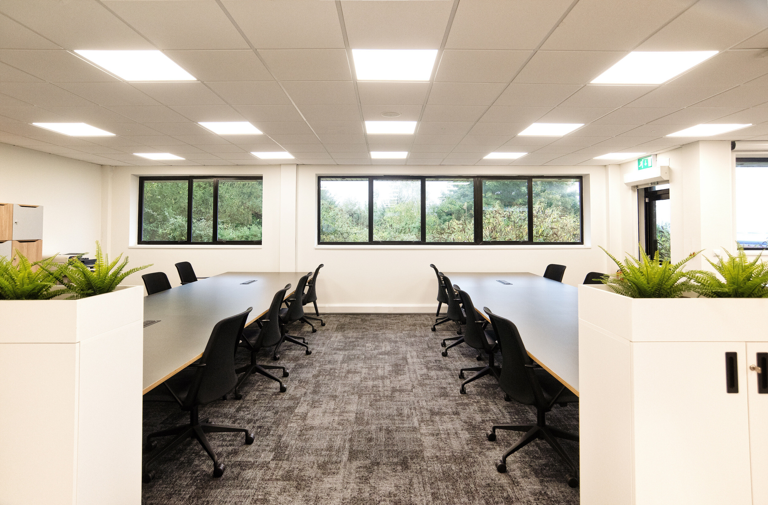 Dedicated workspace in the Koin office, designed by Two, offering a quiet and focused setting with large windows and ergonomic seating.