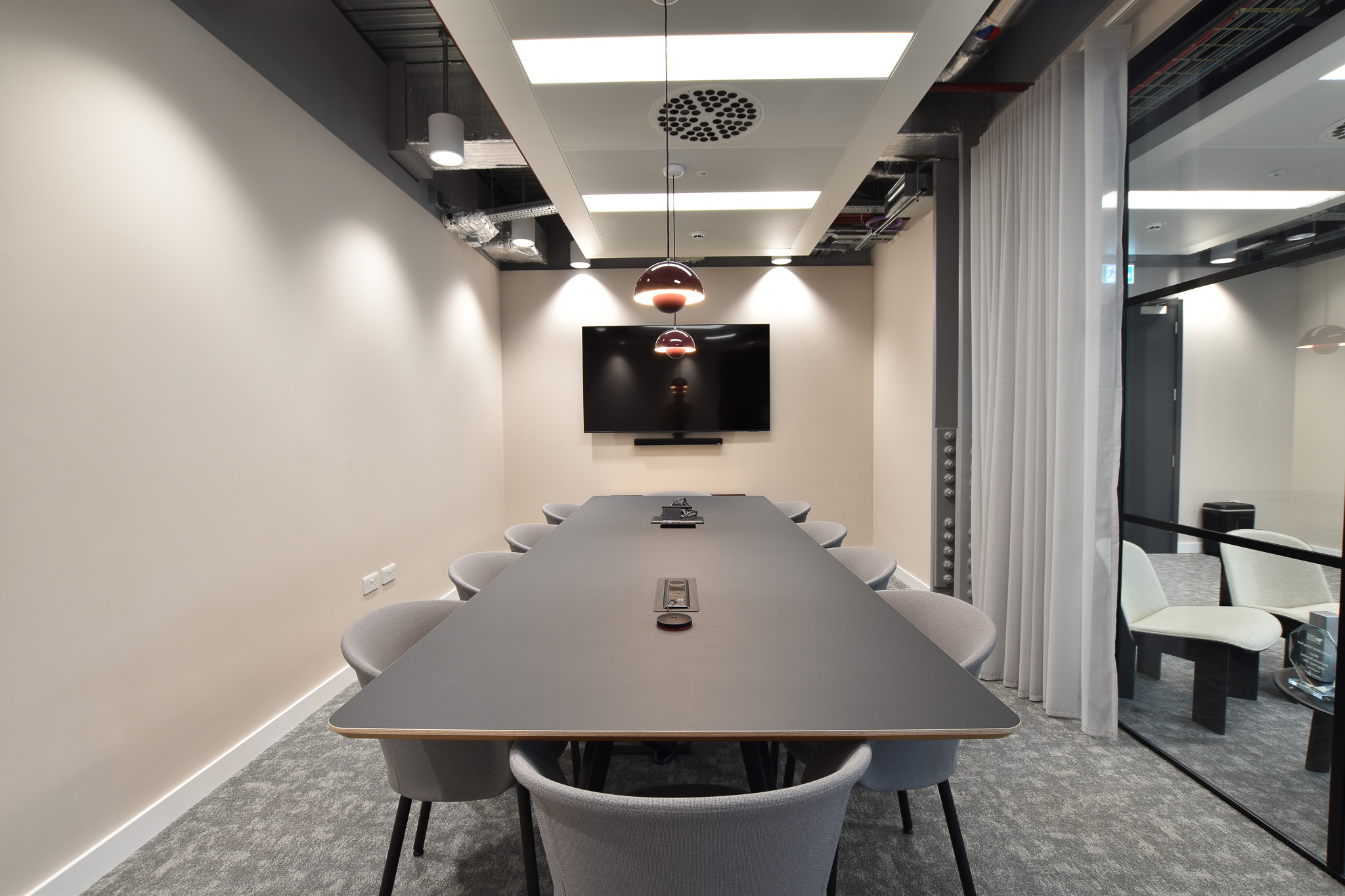 Landsec Nova North office space designed by Two, offering a modern conference setting with natural light and a stylish dark table.