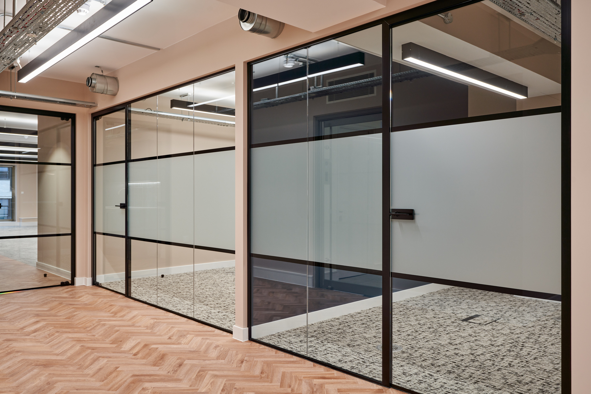 Frosted glazing with black frames in the Nolan Partners office, designed and built by Two.