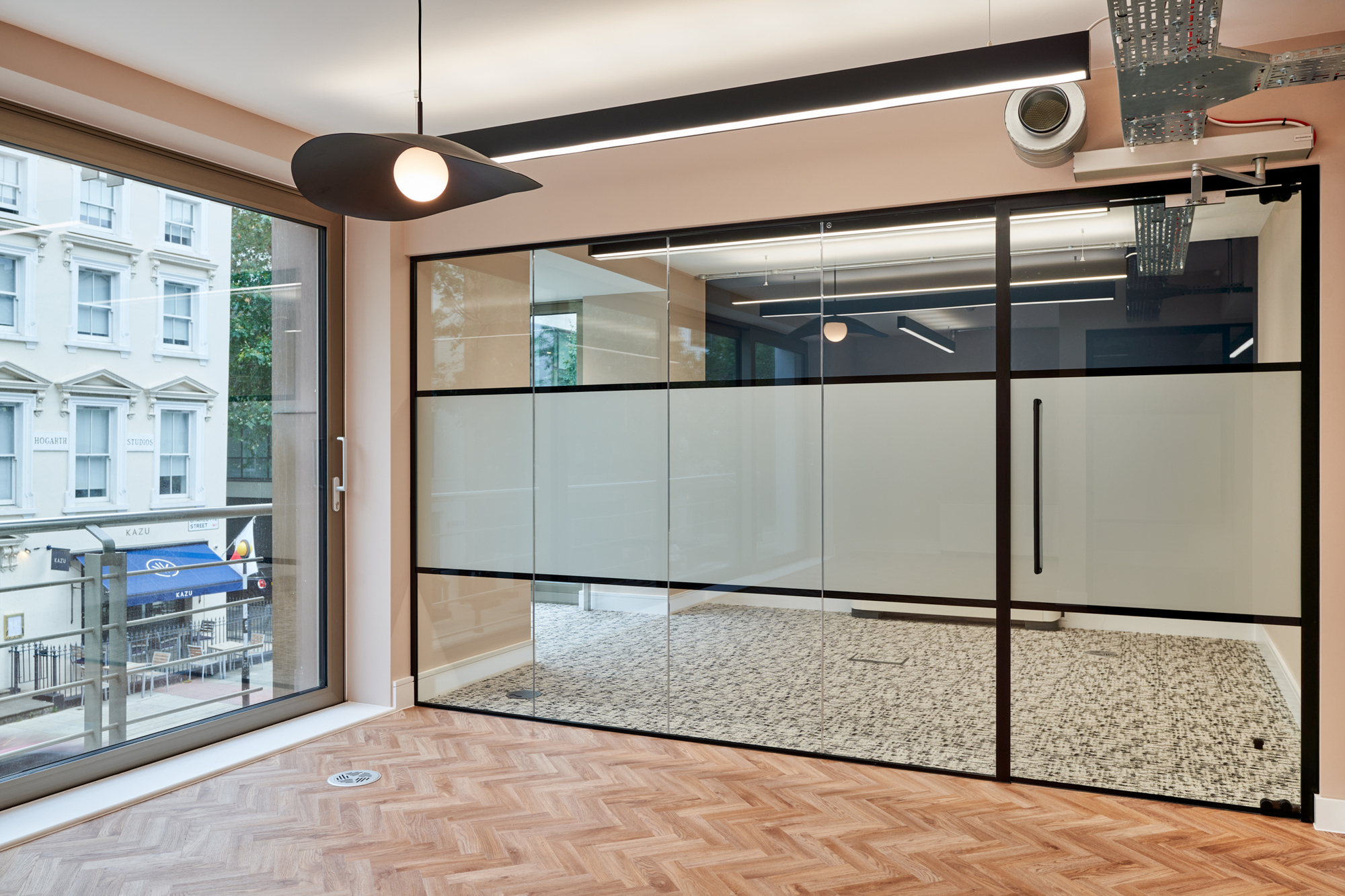 Bright meeting room with glazing and a view of the street outside for Nolan Partners.