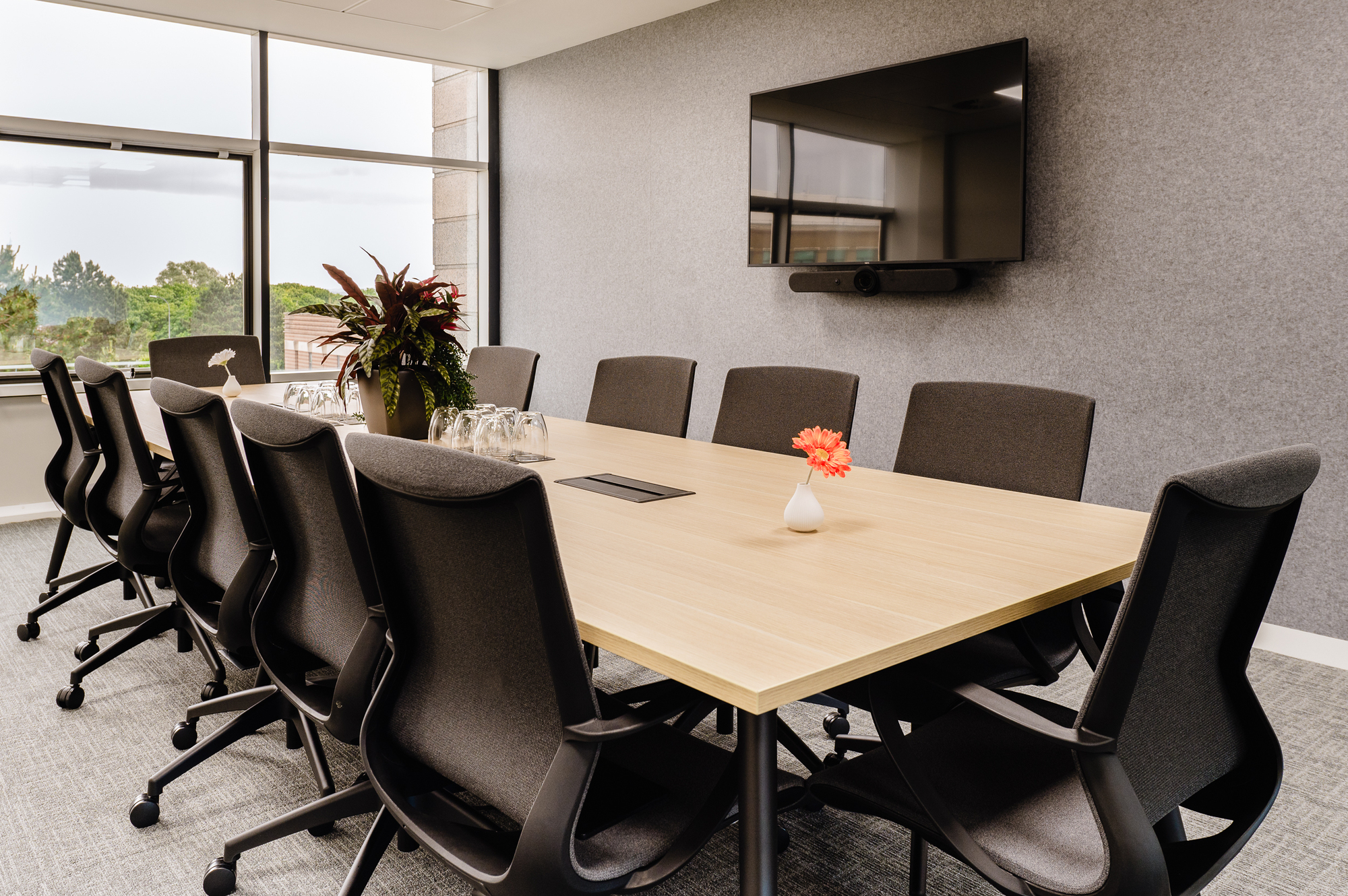 Bright meeting room at Serendipity Labs Bristol, designed by Two for NewFlex, featuring ergonomic seating and a large window.