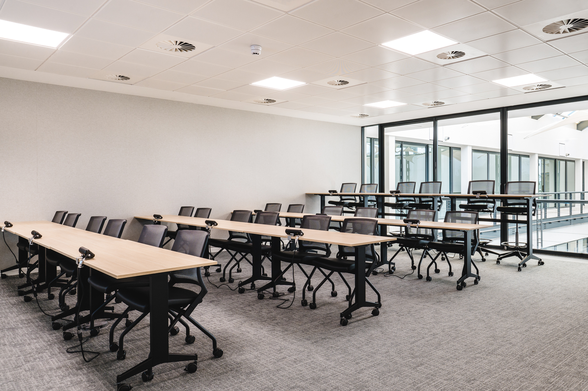 Well-equipped training room at Serendipity Labs, featuring tiered seating and mobile desks for flexible learning and collaboration