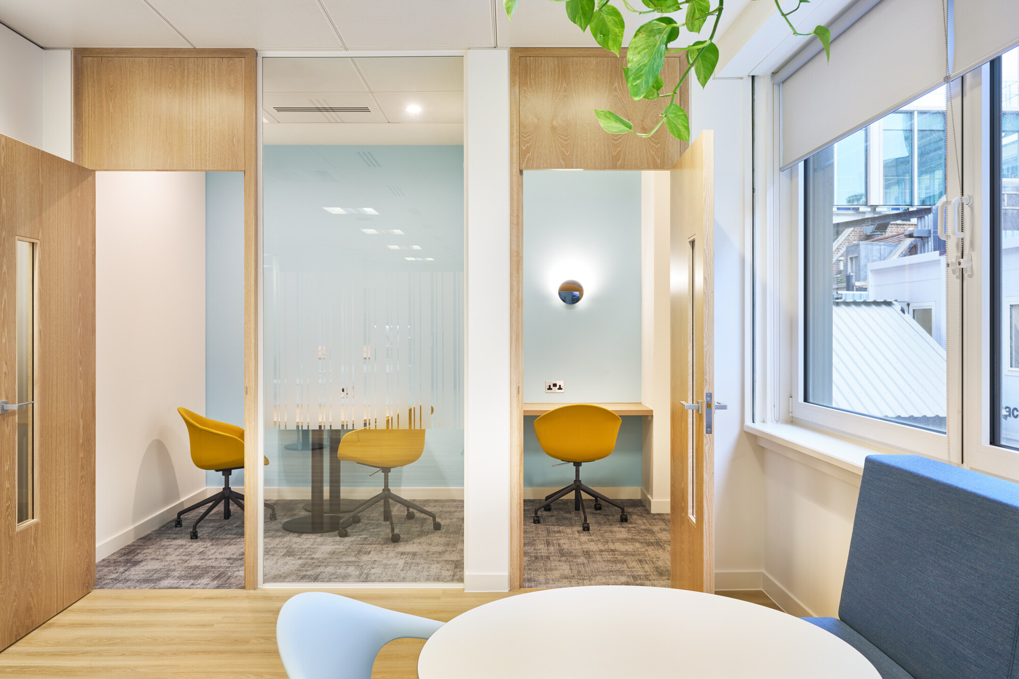 Tech UK breakout space with hanging greenery, yellow seating, and small quiet zones