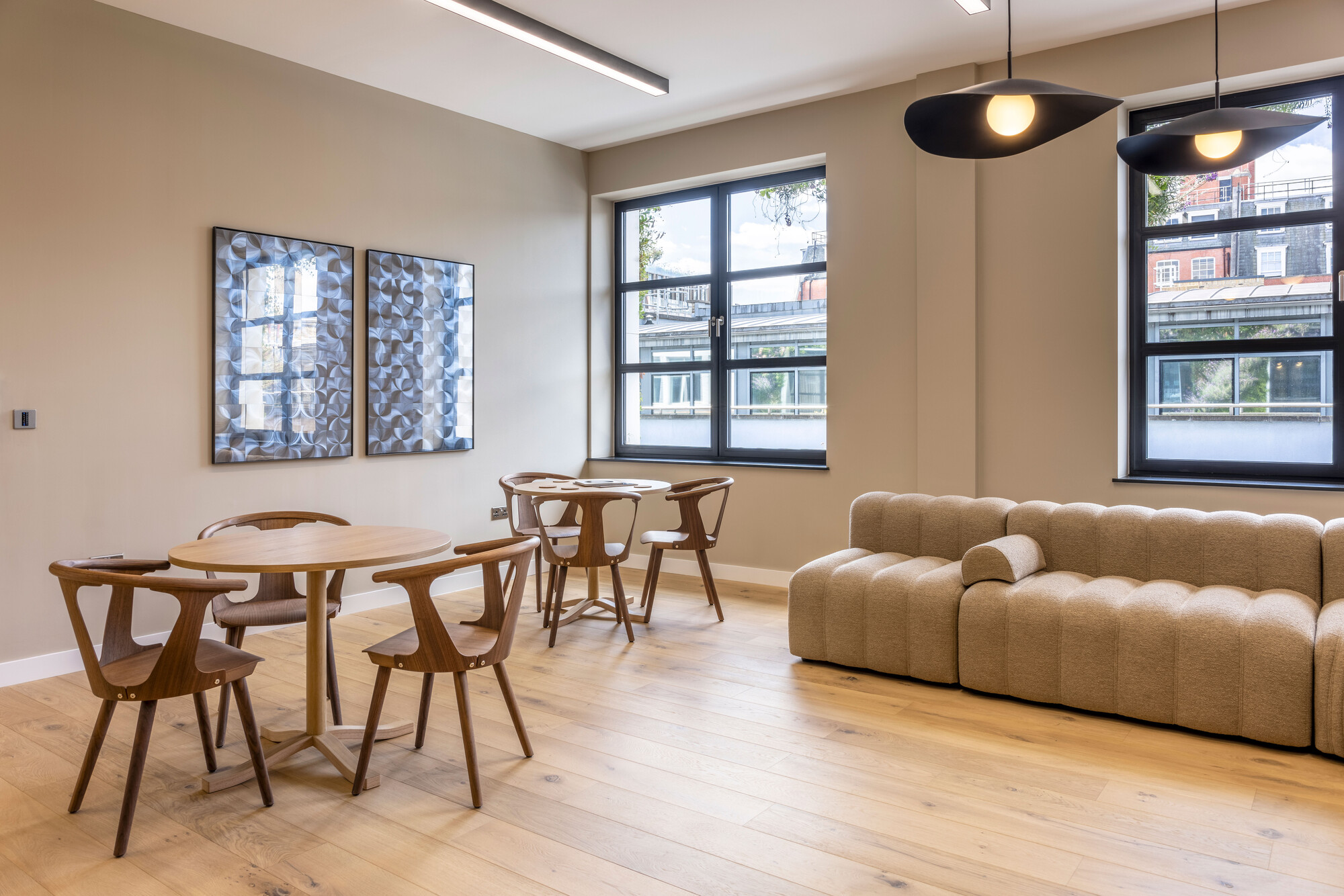 Breakout area at Transition's London workspace, designed by Two with Scandinavian-inspired furniture and sustainable timber flooring.