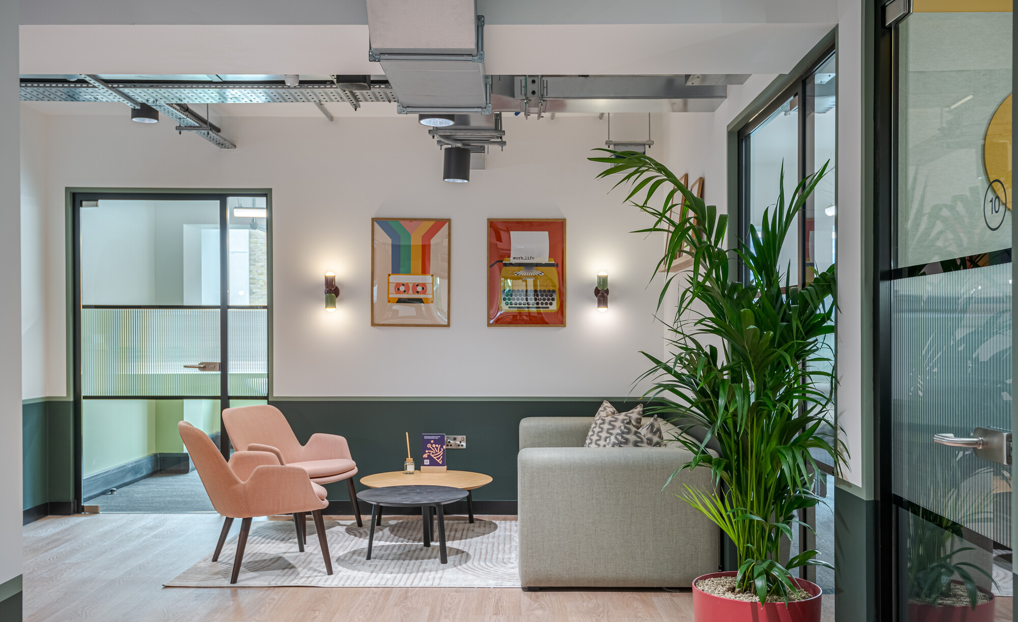 Lounge area at the Typewriter Building featuring mid-century modern furniture and Work.Life-branded wall art, designed by Two.