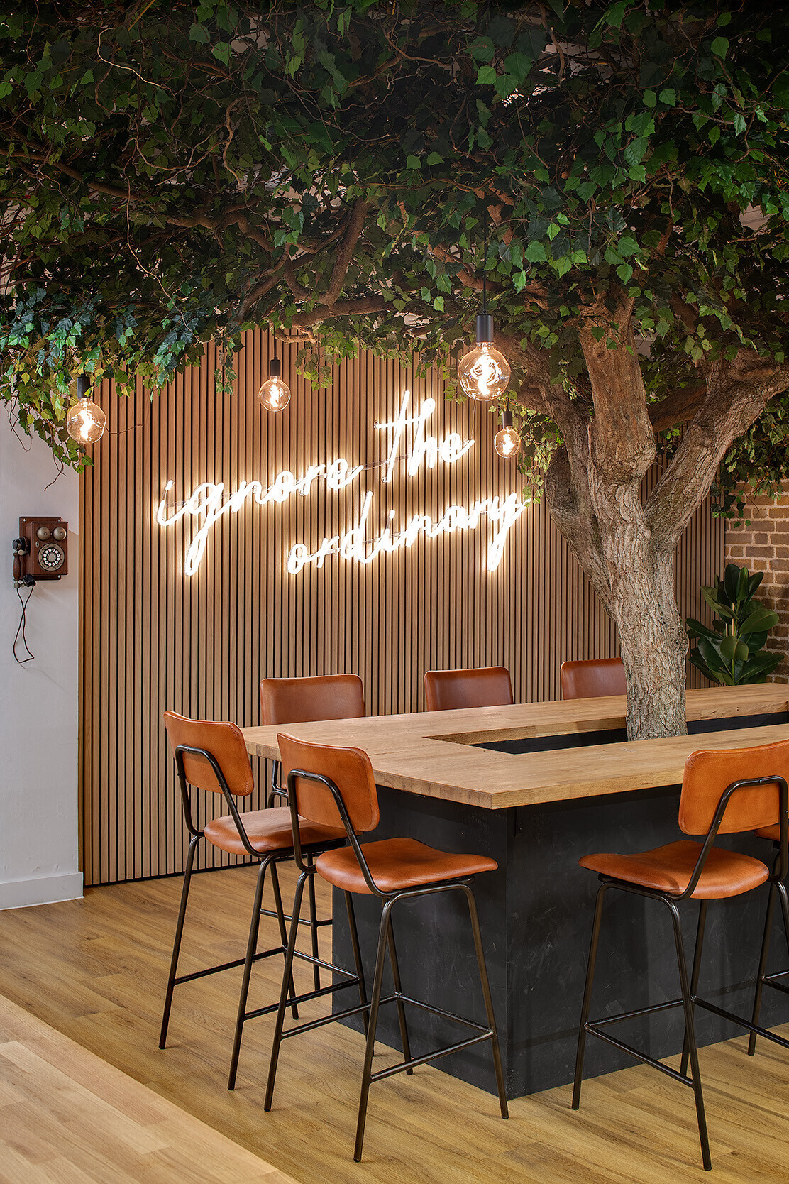 Wiser's central collaboration table with a bespoke tree centrepiece and neon 