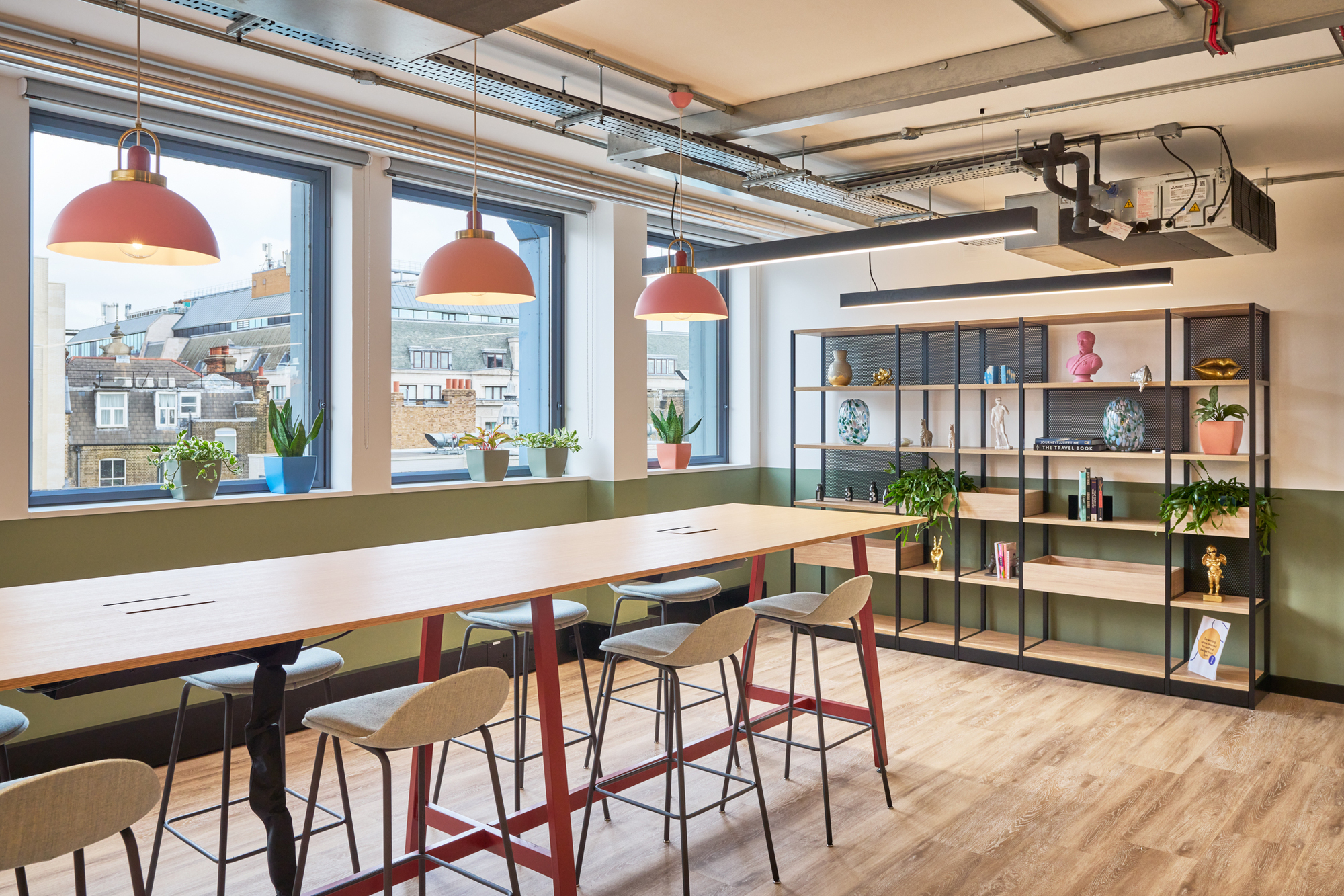 Collaborative workspace at Work.Life Waverly House, designed by Two, with a long table, colourful pendant lights, and shelving for a dynamic setting