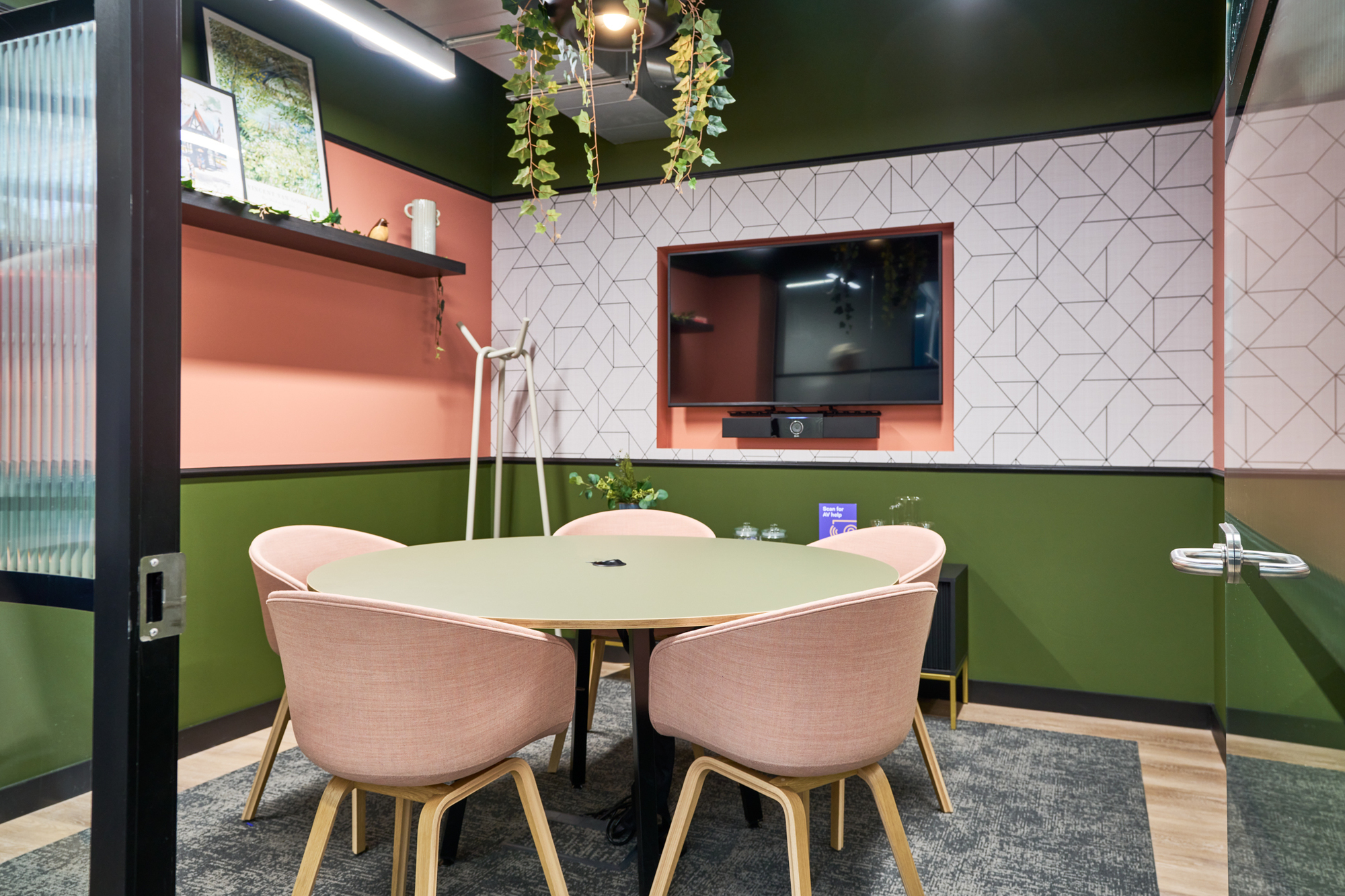 Intimate meeting room at Work.Life Waverly House designed by Two, with earthy tones, pink seating, and geometric wall patterns for a creative atmosphere.