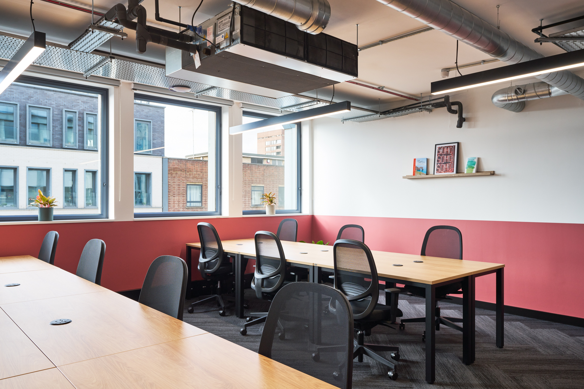 Bright workspace at Work.Life Waverly House designed by Two, featuring modern desks, ergonomic chairs, and Soho-inspired decor against a warm colour palette.