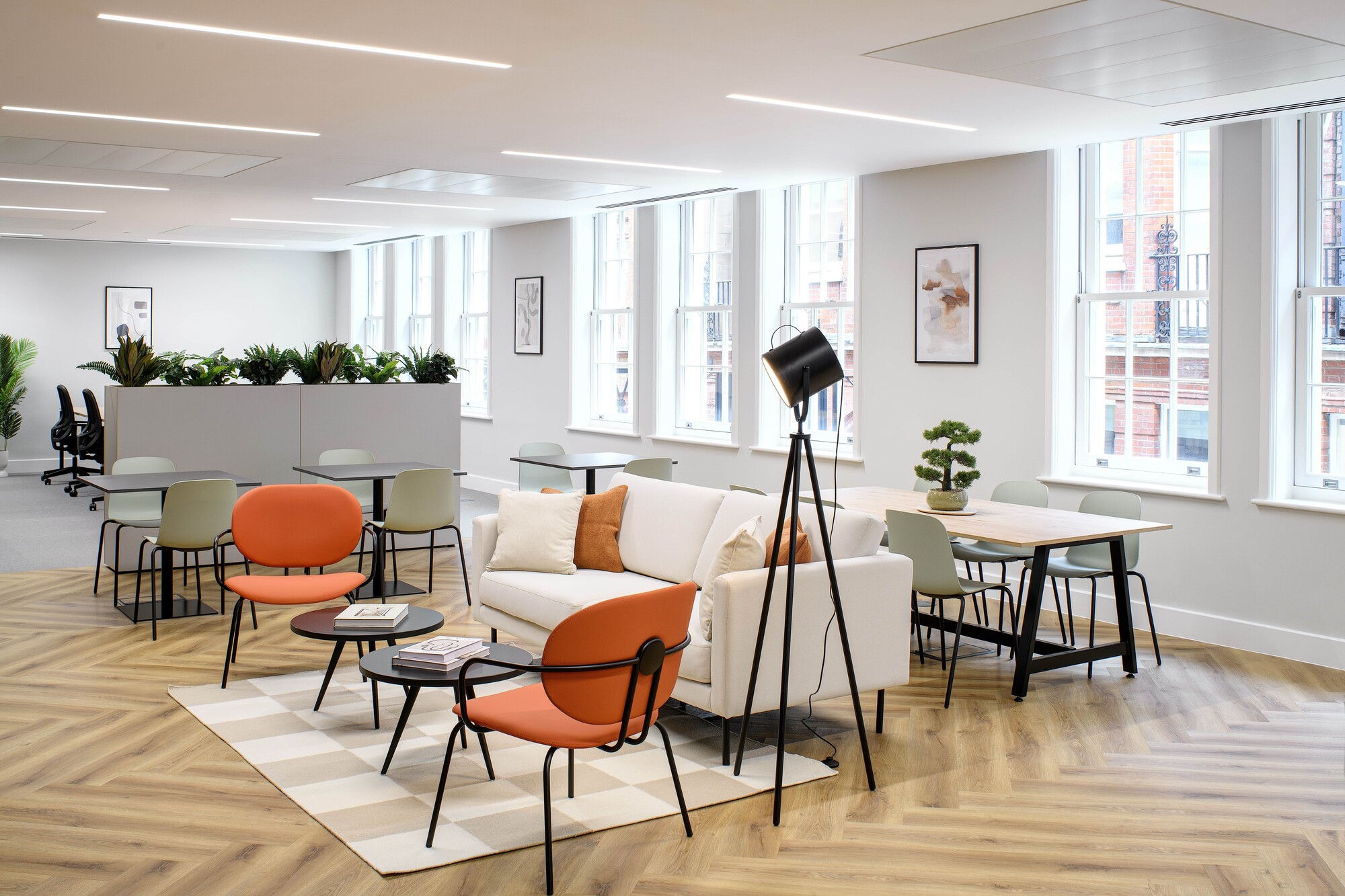 Breakout area at the Tenant-Ready™ workspace at 1 Old Queen Street by Two, featuring herringbone vinyl flooring, soft seating, and natural light to create a welcoming environment.