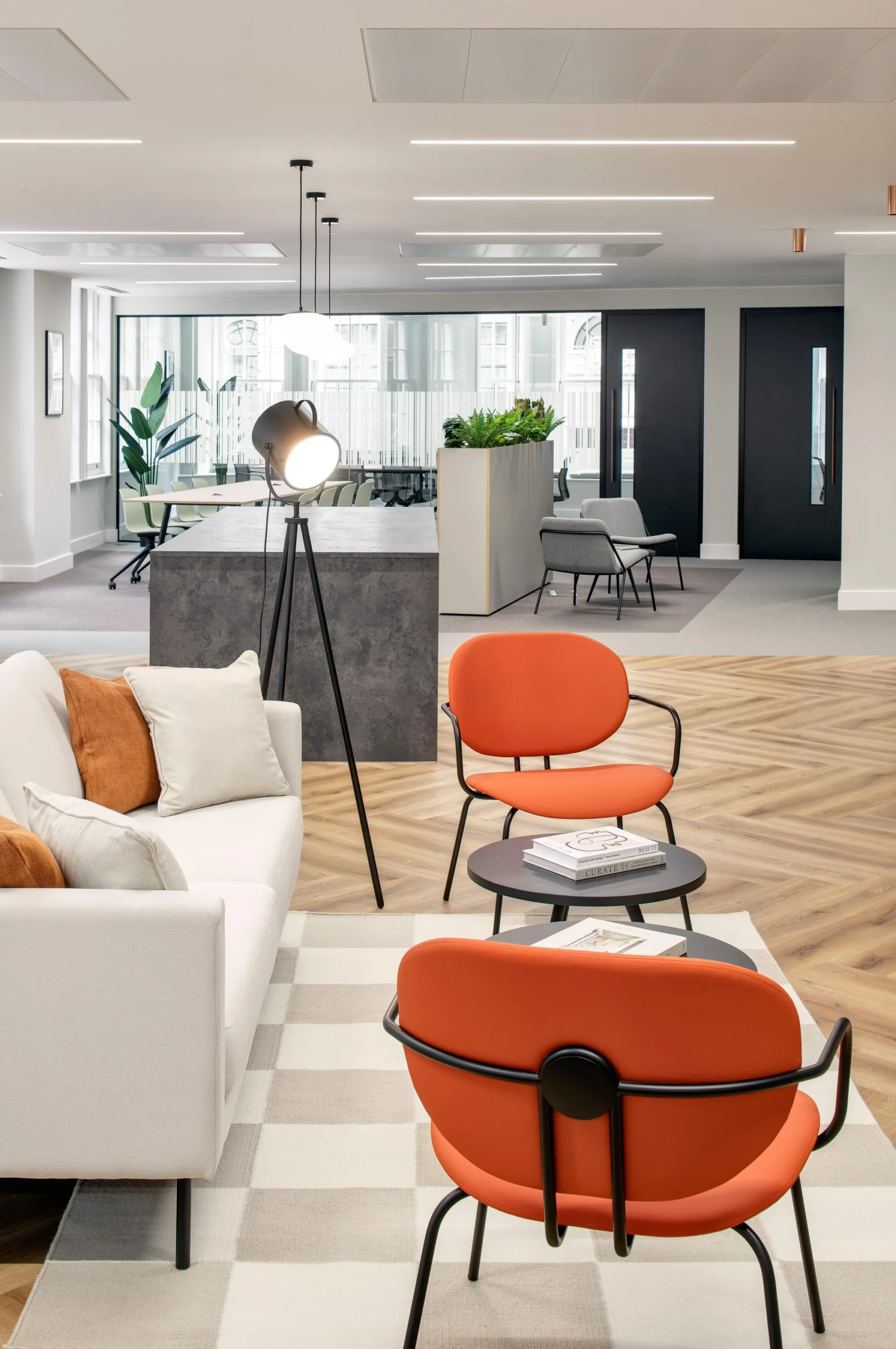 Seating area with vibrant orange chairs and neutral accents in the Tenant-Ready workspace at 1 Old Queen Street, designed by Two.