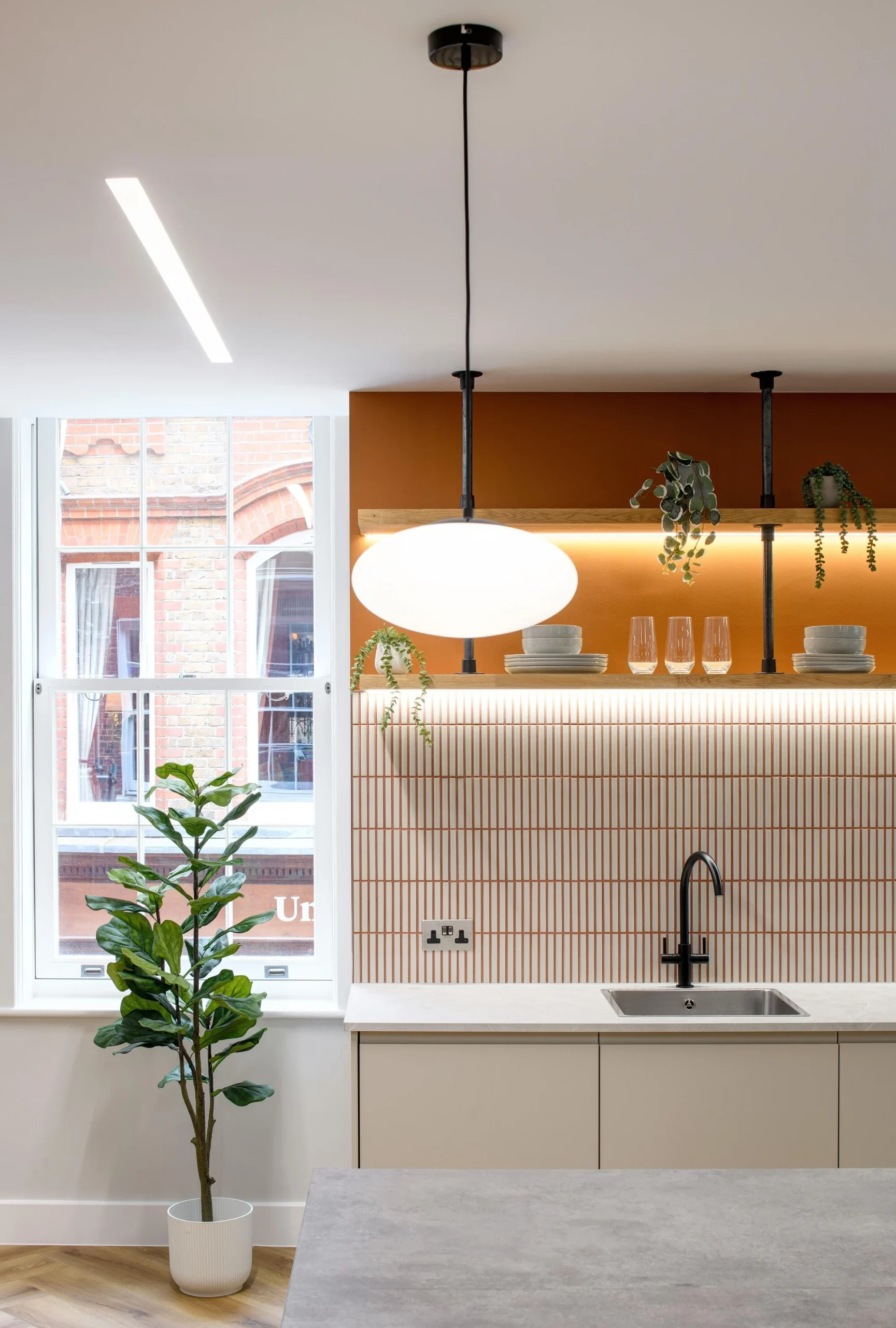 Teapoint area with orange tile backsplash and black fixtures in the Tenant-Ready™ workspace at 1 Old Queen Street by Two.