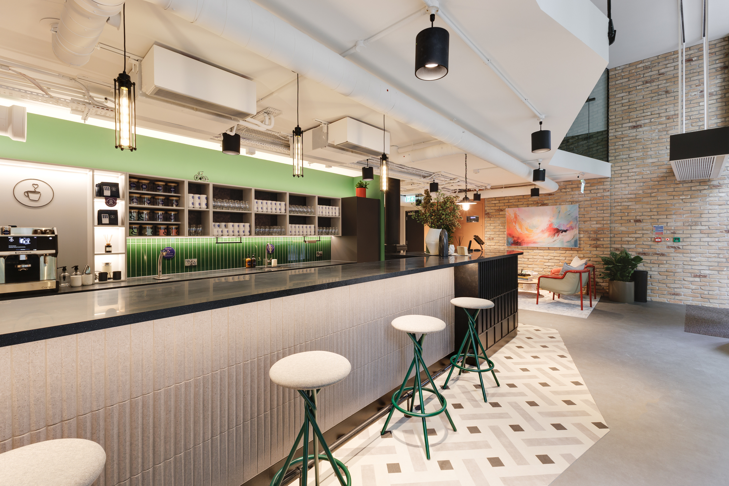 Ground floor bar-style teapoint at Work.Life Clerkenwell Green with green tiled splashback, patterned flooring, and modern lighting, completed by Two.